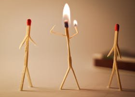 Artistic matchstick figures arranged with flames showcasing creativity and craftsmanship.